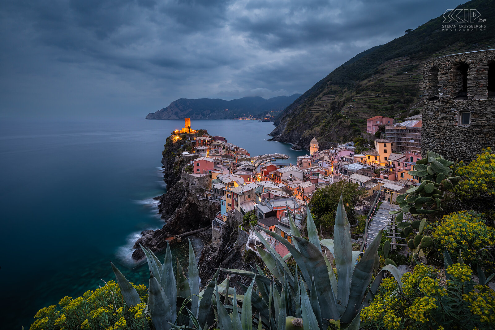 Vernazza - Blue hour Vernazza is one of the five villages of Cinque Terre. It has beautifully colored houses and a particularly lovely harbor and bay. This photo was taken from a well-known photo location on a south-facing slope during blue hour on an overcast evening. Stefan Cruysberghs